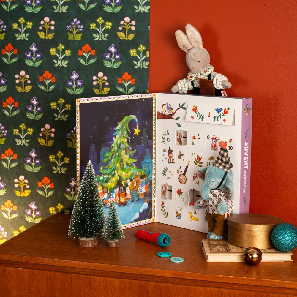 Open Les Minouchkas advent calendar showing numbered pockets and story scenes