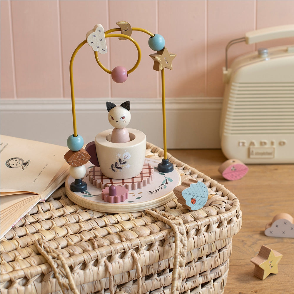 Moulin Roty wooden bead maze on wicker basket lifestyle shot