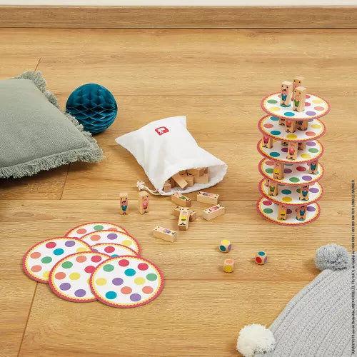 JANOD Acrobat game components unboxed on wood floor with drawstring bag and dice