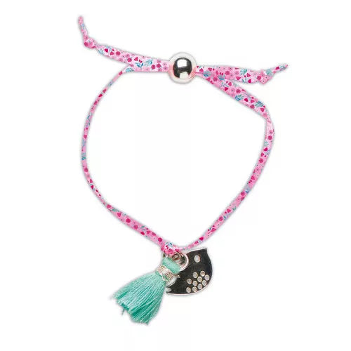 Pink floral ribbon bracelet with black bird charm and teal tassel