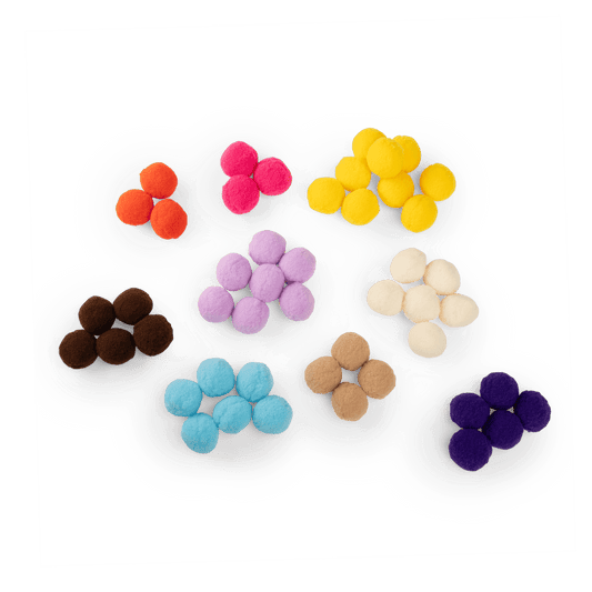 Assorted multicolor felt pom-poms for Les Toupitis tree activity including orange pink and lavender