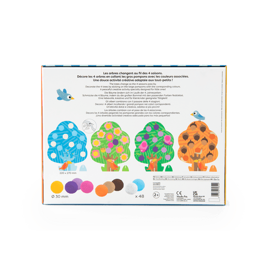 Moulin Roty activity instruction sheet showing color-coded pom-pom placement for seasonal trees