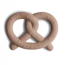 Close-up of MUSHIES tan silicone pretzel teether with salt crystal texture detail