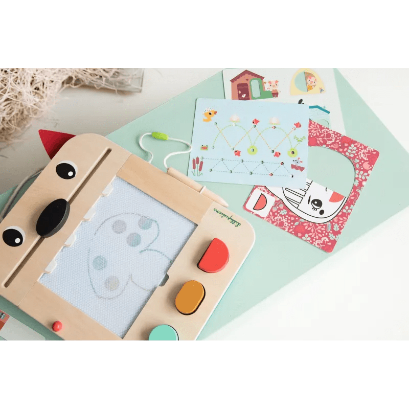 Top view of wooden wolf drawing toy with heart sketch and multiple activity cards