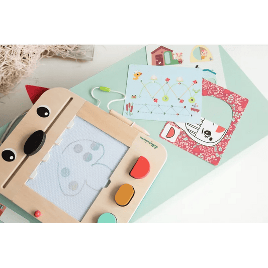 Top view of wooden wolf drawing toy with heart sketch and multiple activity cards