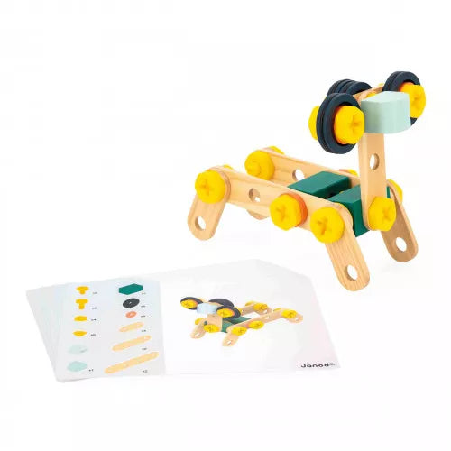 Assembled JANOD wooden animal robot toy with green blocks and black wheels next to instructions
