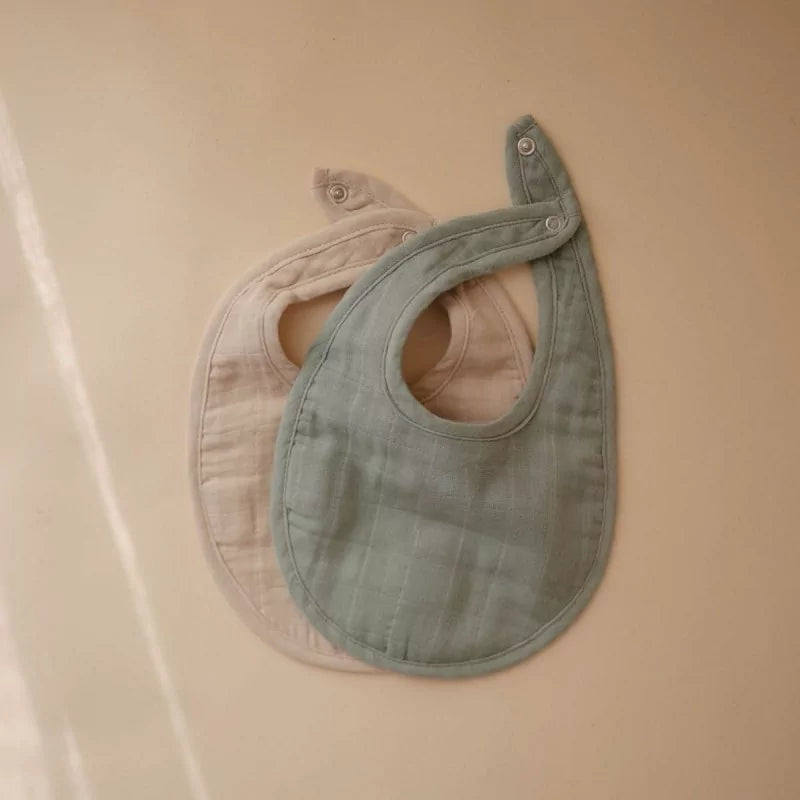 MUSHIES Roman green and Fog muslin bibs flat lay