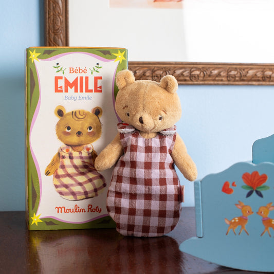Bébé Emile plush bear wearing checkered swaddle next to packaging box