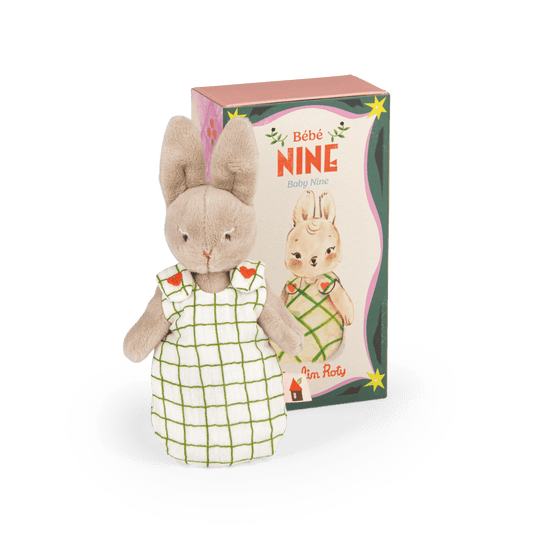 Bébé Nine plush toy standing next to illustrated packaging box showing character art