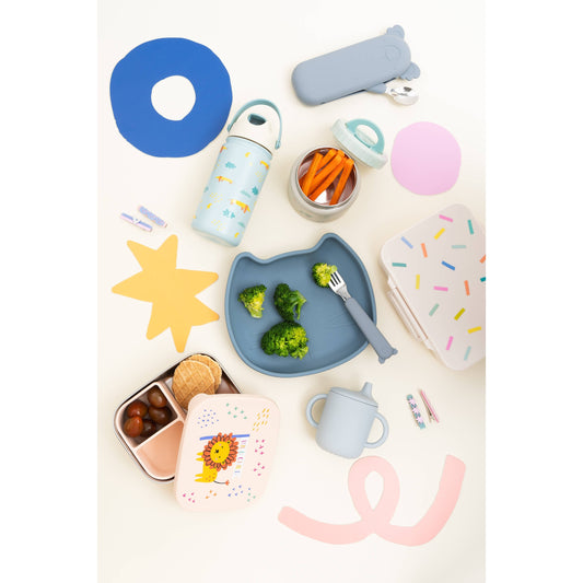 Kids meal flat-lay with lion lunchbox cat plate and utensil case
