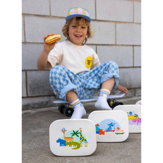 Three stainless steel lunchboxes featuring jungle dog and fruit designs