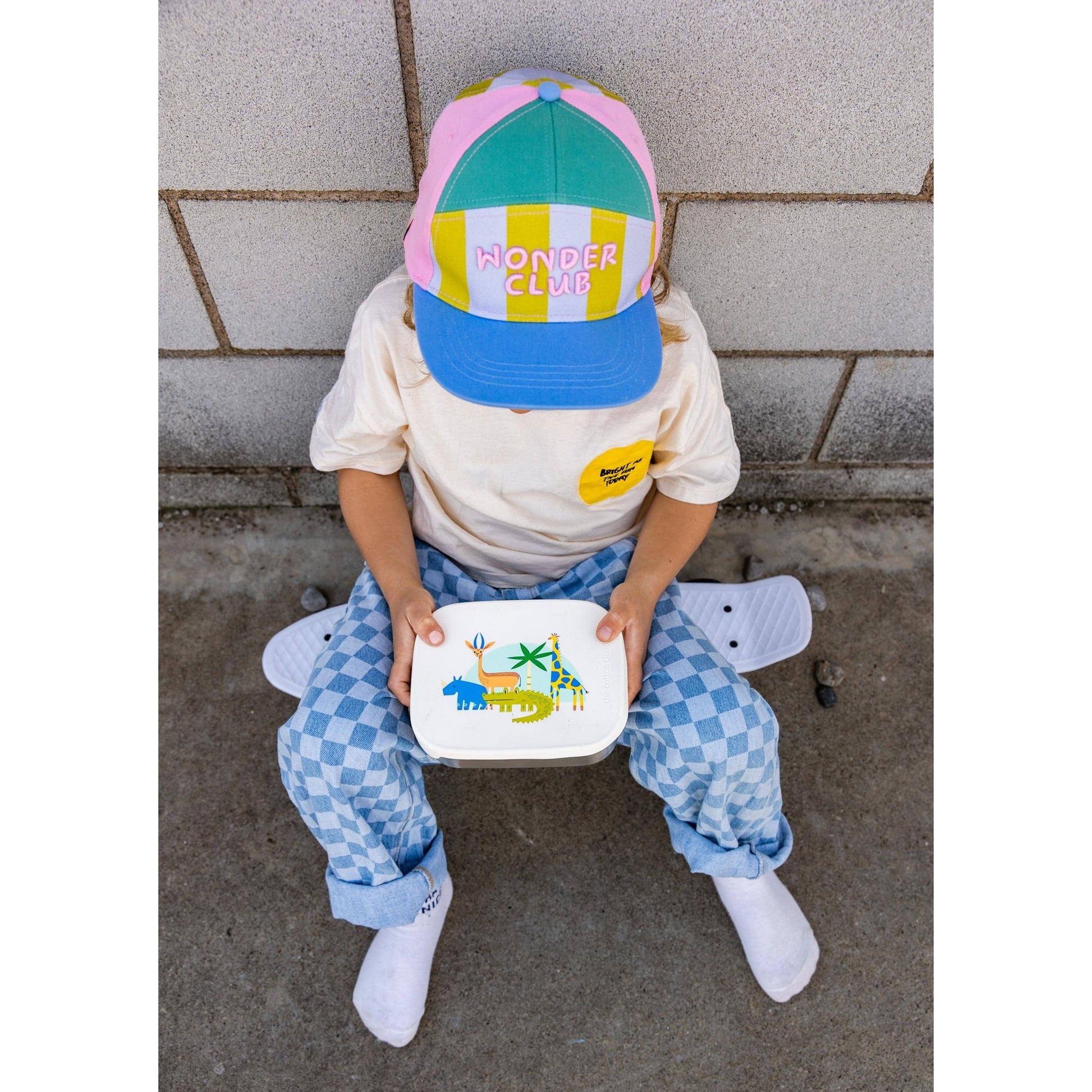 Child holding stainless steel Croc Rock lunchbox with jungle animal lid