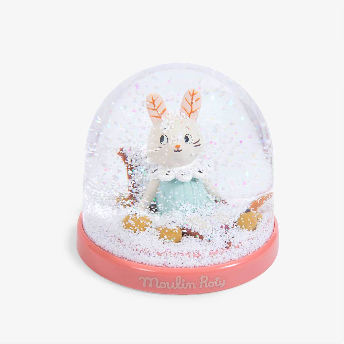 Top view of Moulin Roty snow globe with dense white glitter and coral base