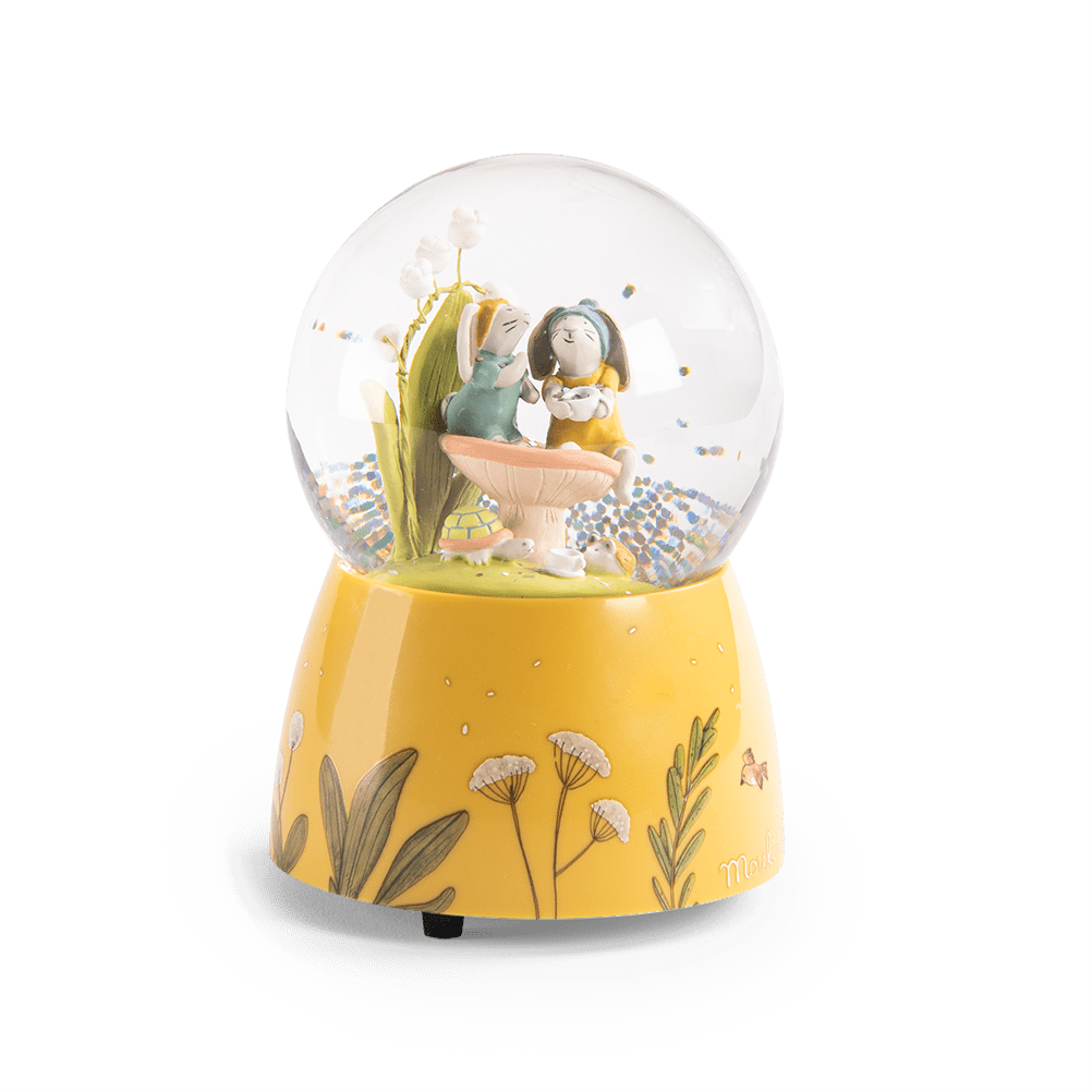Front view of musical snow globe with two rabbits and glitter
