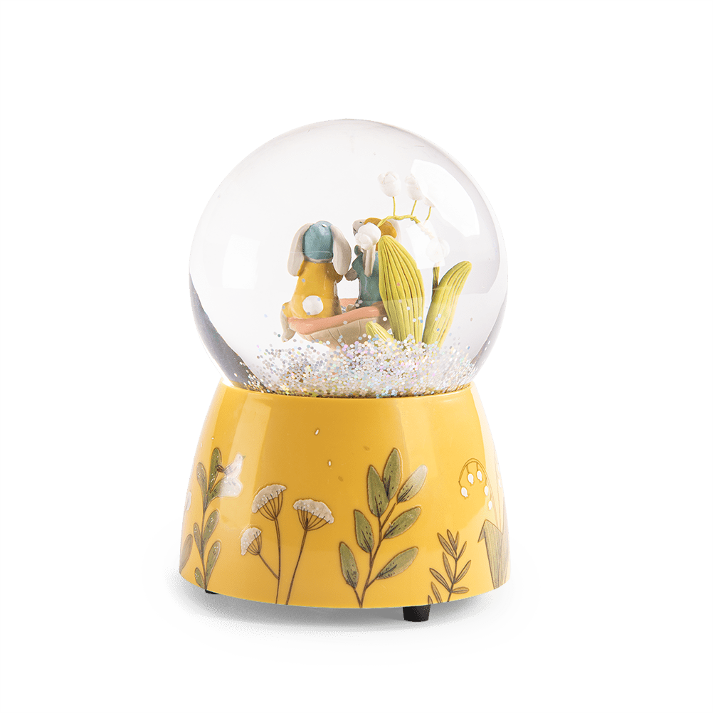 Yellow botanical base detail of Moulin Roty musical snow globe