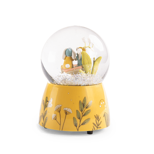 Yellow botanical base detail of Moulin Roty musical snow globe