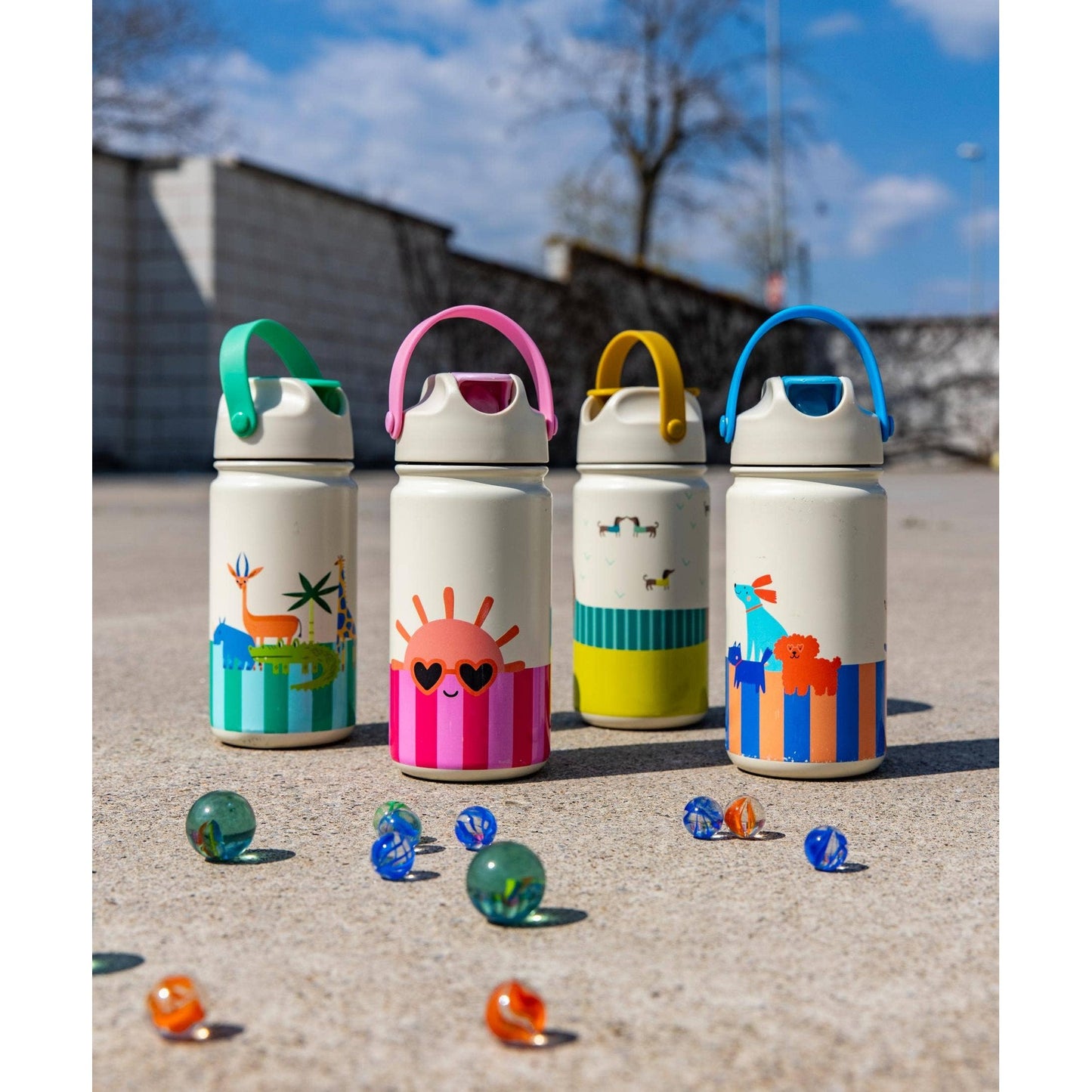 Four insulated bottles with green jungle pink sun yellow dogs and blue scarf designs