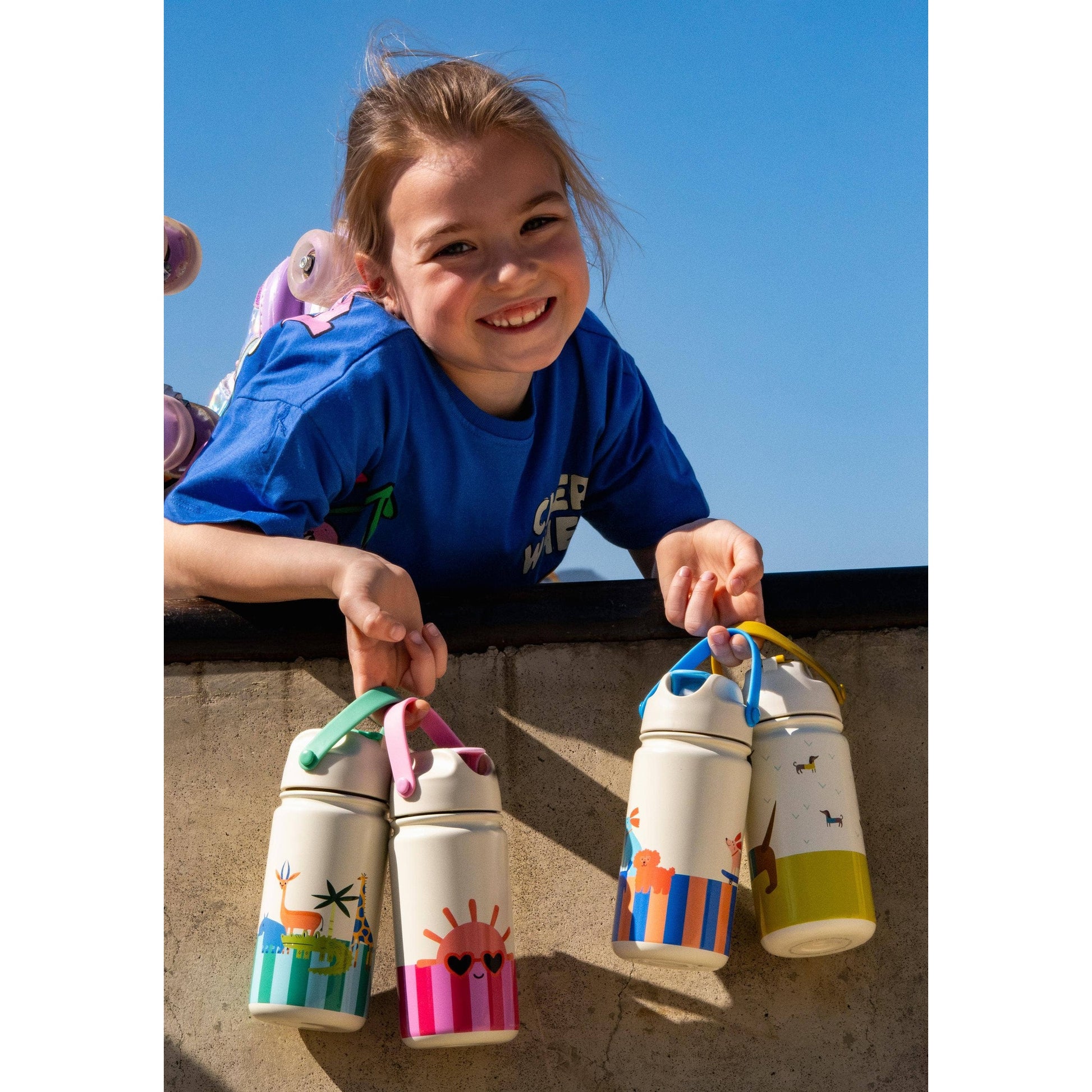Four colorful children's insulated bottles featuring giraffe sun lion and dachshund designs