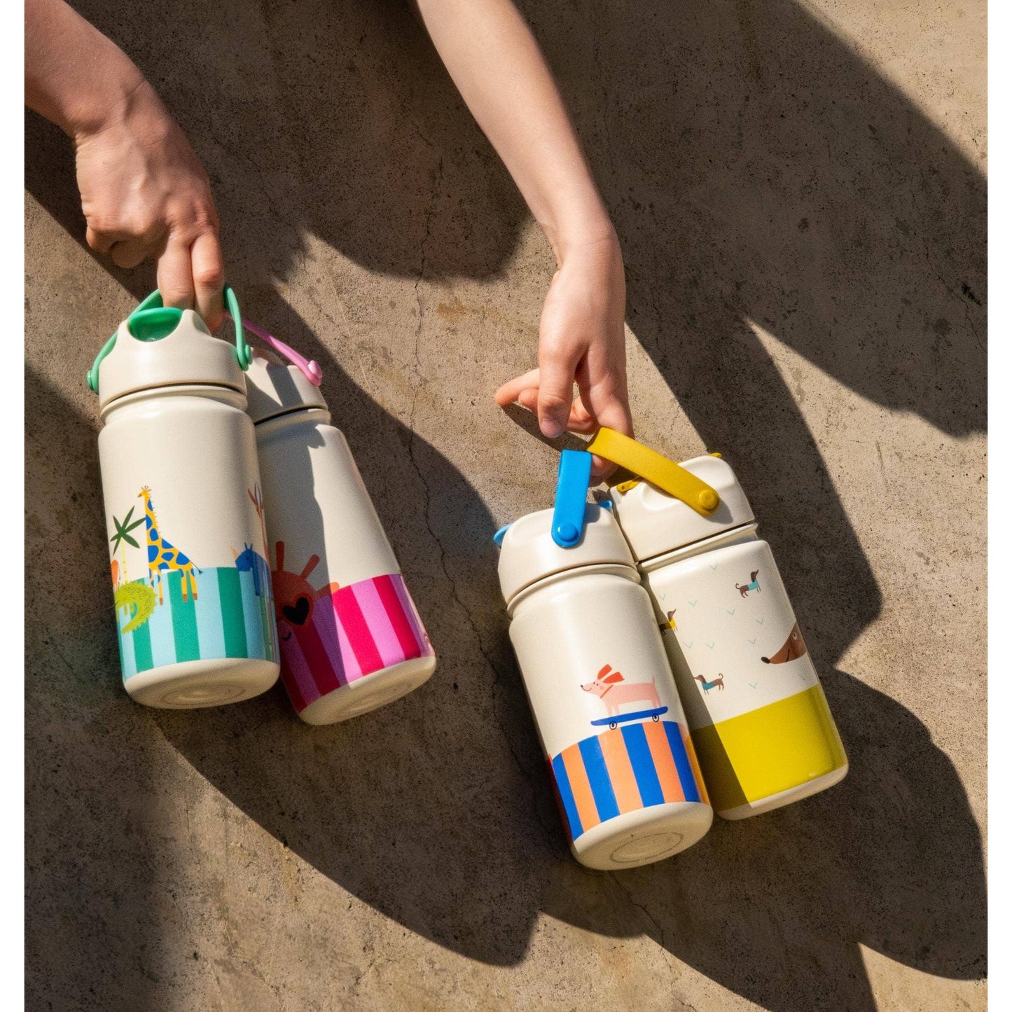 Group of four kids insulated bottles with silicone handles and whimsical animal graphics