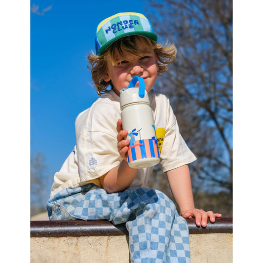 Child drinking from white bottle with bird scooter graphic and blue handle