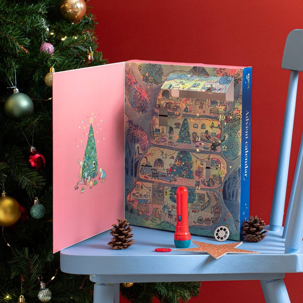 Open Moulin Roty advent calendar showing numbered pockets and animal illustrations