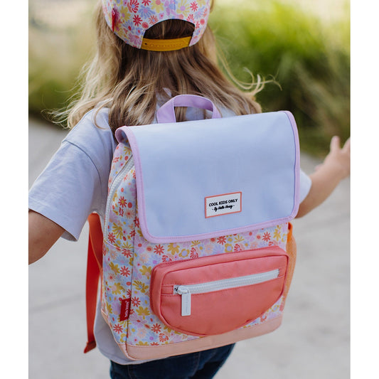 Child wearing Hello Hossy floral backpack outdoors with matching hat