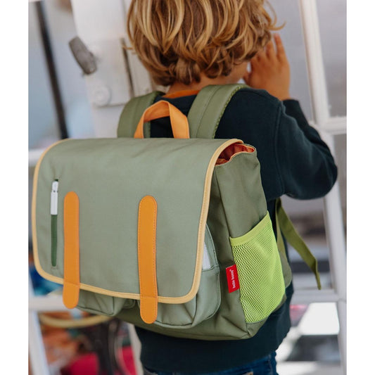 Child wearing olive green Mini Safari backpack with lime mesh side pocket