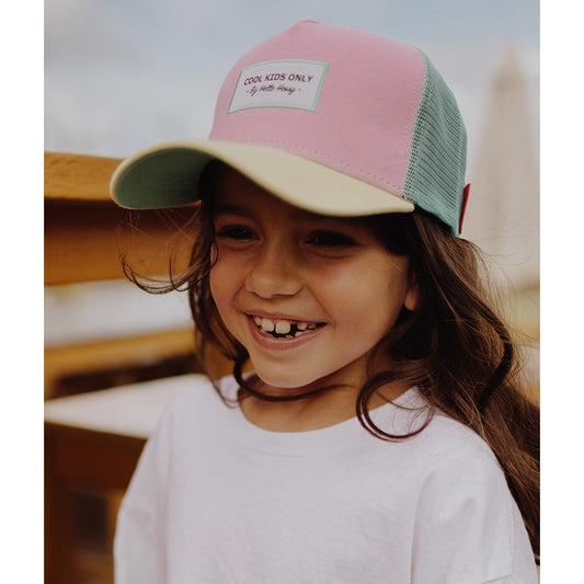 Girl wearing pink and mint green Hello Hossy trucker cap front view