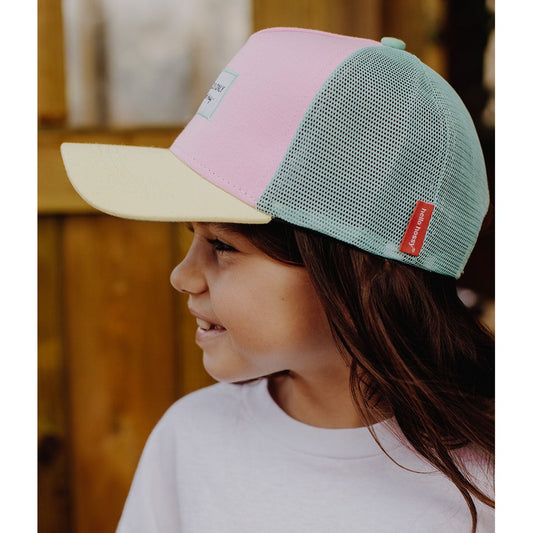 Pink and mint green Hello Hossy trucker cap side view on girl