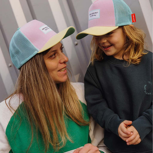 Mom and child matching pastel pink and blue Hello Hossy trucker caps