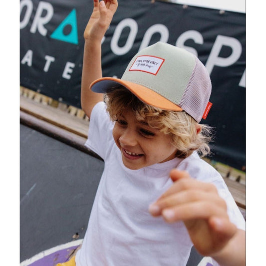 Blonde boy smiling while wearing green and orange Hello Hossy kids trucker hat