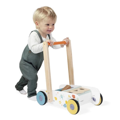 Child walking with Janod wooden push walker for toddlers