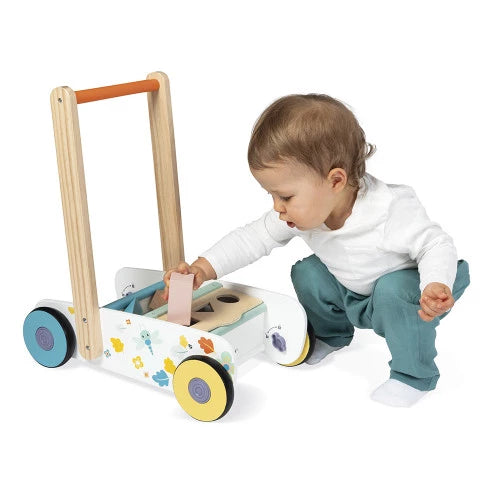 Toddler playing with Janod wooden walker shape sorting blocks