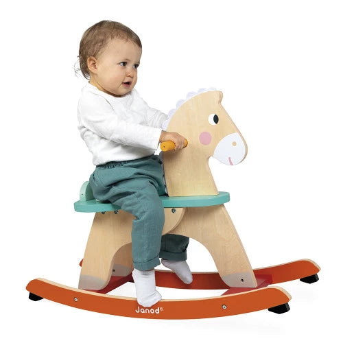 Toddler riding Janod wooden rocking horse toy