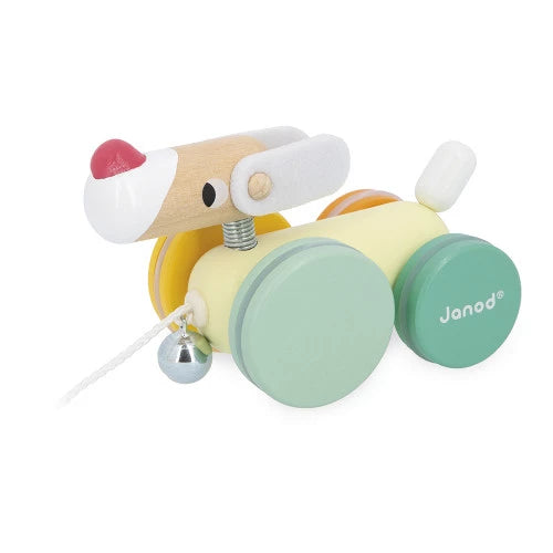 Close-up of Janod wooden pull-along dog with felt ears and colorful wheels