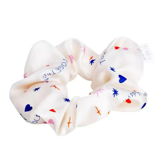 Cream scrunchie with hearts stars airplanes and text print