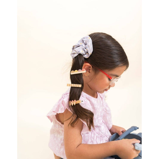 Child ponytail with purple dot scrunchie and wooden style clips