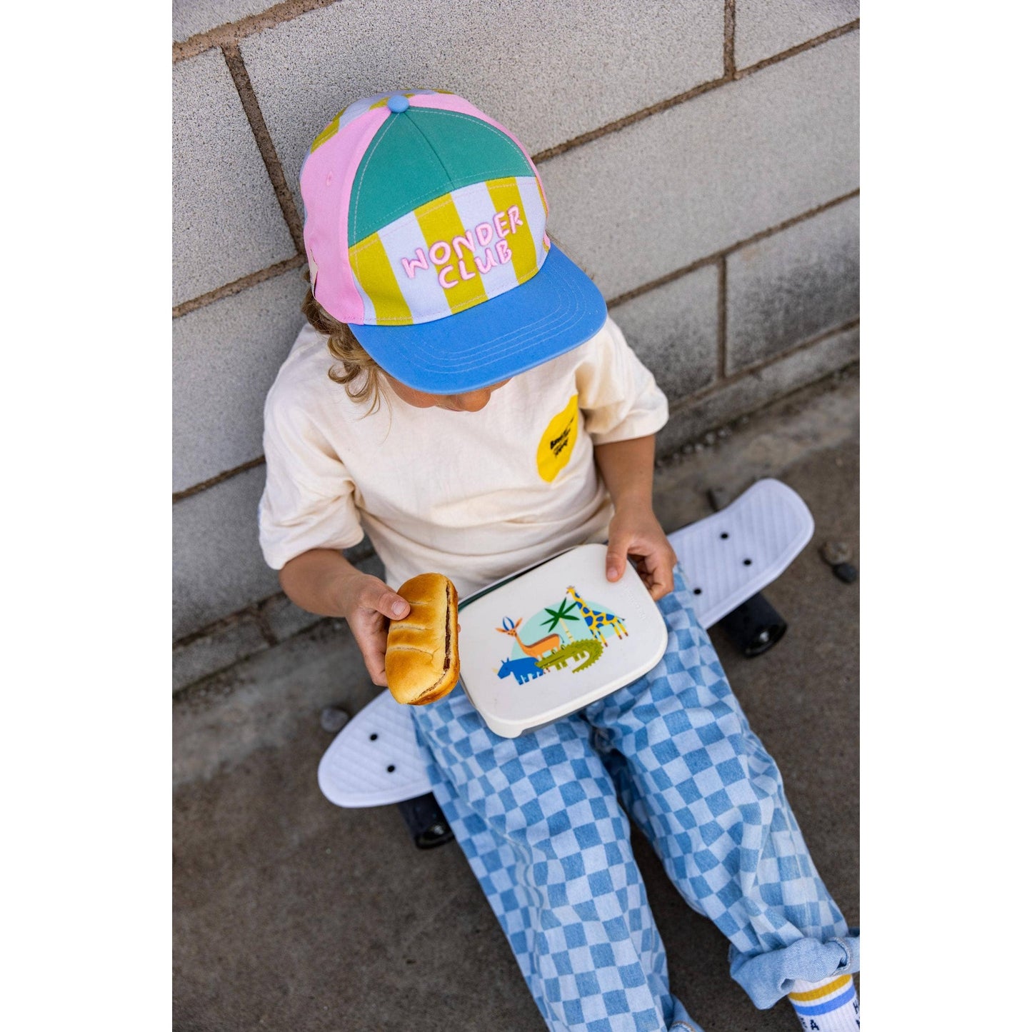 Top view child holding closed animal print lunchbox