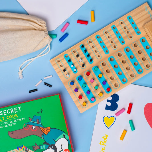 Flat lay of Code Secret wooden board game with scattered colored pegs