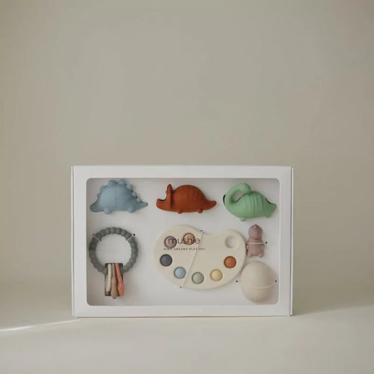 Closed white MUSHIES Dino Dreams gift box showing silicone dinosaur toys