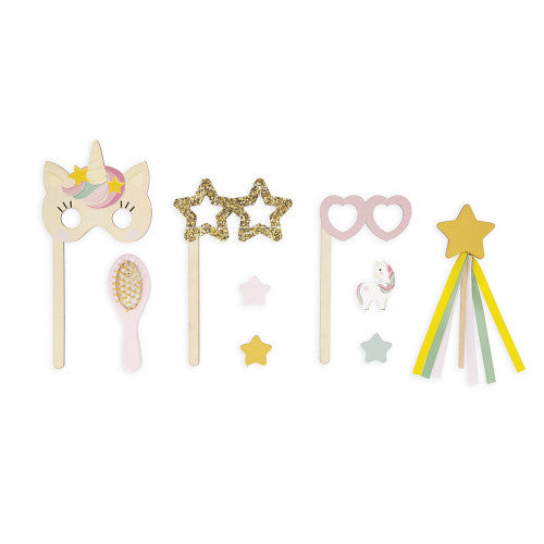 Flat lay of 10 wooden unicorn vanity accessories including mask brush and wands