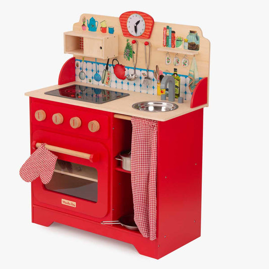 Side view of red wooden play kitchen showing gingham oven mitt
