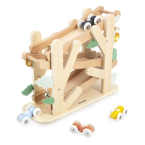 Assembled JANOD wooden ramp toy with four cars and decorative leaves