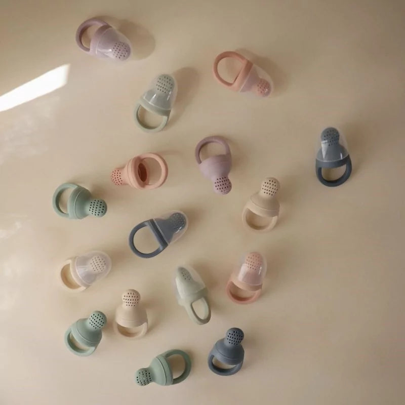 MUSHIES silicone fresh food feeders in pastel colors flat lay