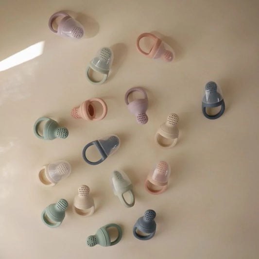 MUSHIES silicone fresh food feeders in pastel colors flat lay