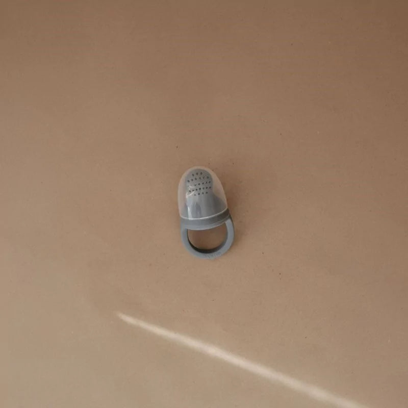 Grey silicone baby feeder with protective cap