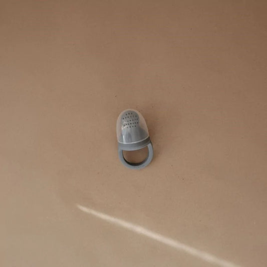 Grey silicone baby feeder with protective cap