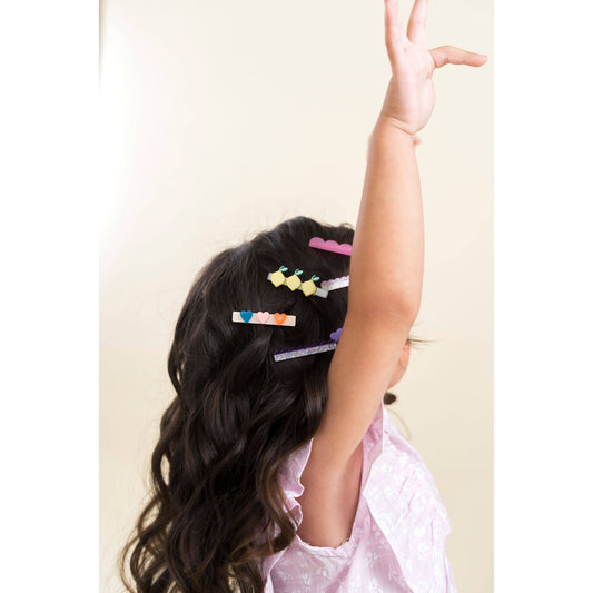 Child wearing lemon heart bird and cloud hair clips
