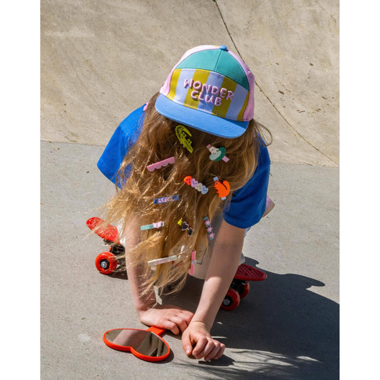 Girl wearing colorful acrylic hair clips in outdoor skate setting