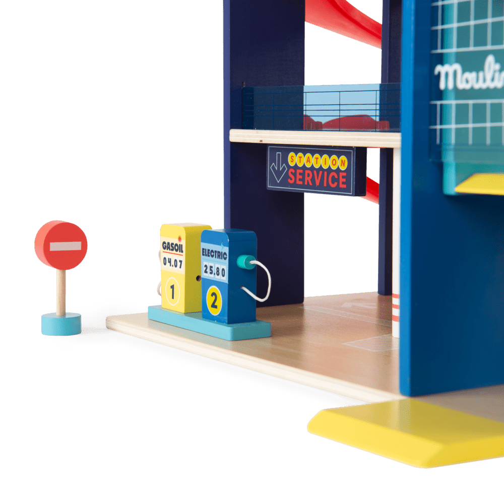 Detail shot of wooden fuel pumps and traffic sign accessories for the Moulin Roty garage set